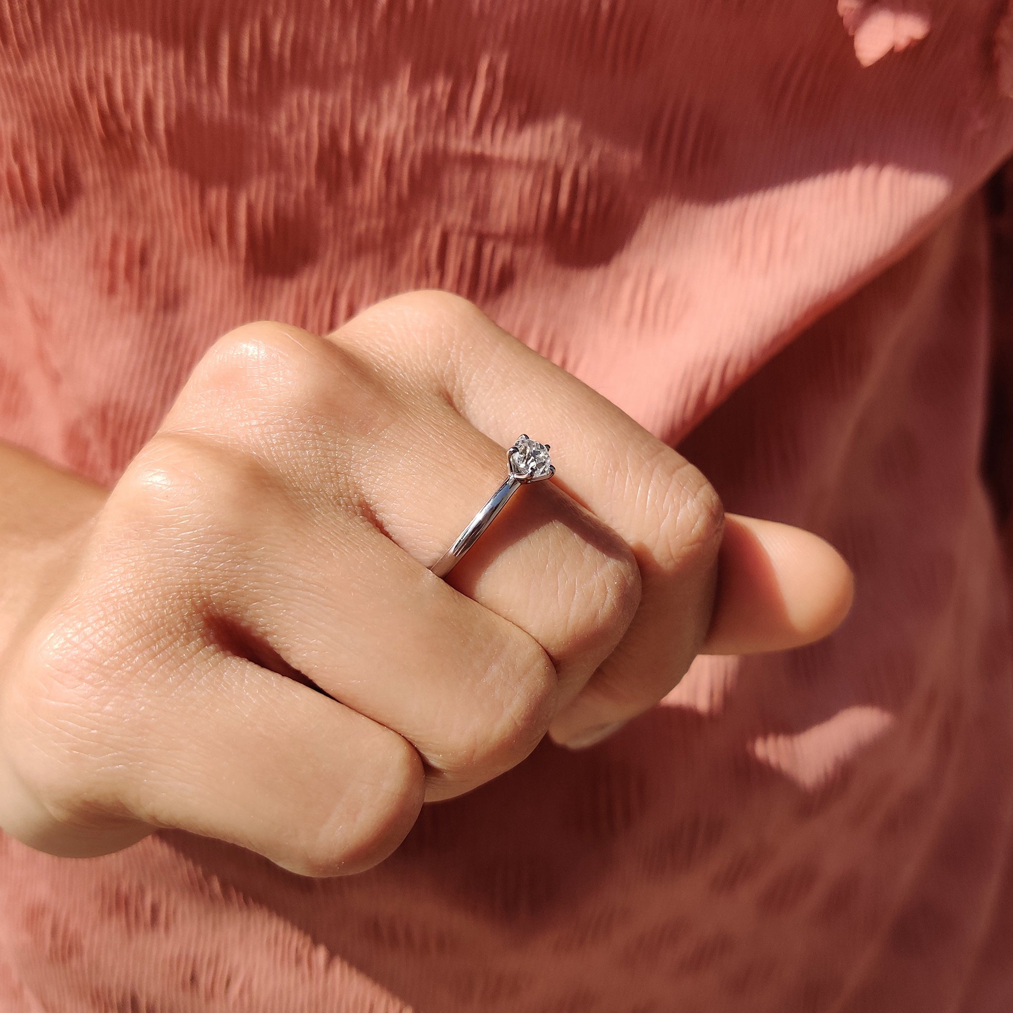 Custom engagement ring featuring a white gold round cut design.