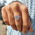 Round halo engagement ring with pave band design.