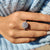 Halo setting with a 4 prong setting for a white gold engagement ring.