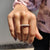 Round cut wedding band made with smooth curved stones.