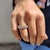 Oval wedding band with round cut Moissanite in a halo setting.