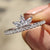 Tiara wedding band featuring a regal design with marquise and round moissanite stones.
