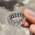 Full eternity band featuring radiant cut stones and a sleek white gold band.
