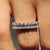 Emerald cut eternity band in white gold with prong settings, crafted for elegant everyday wear.