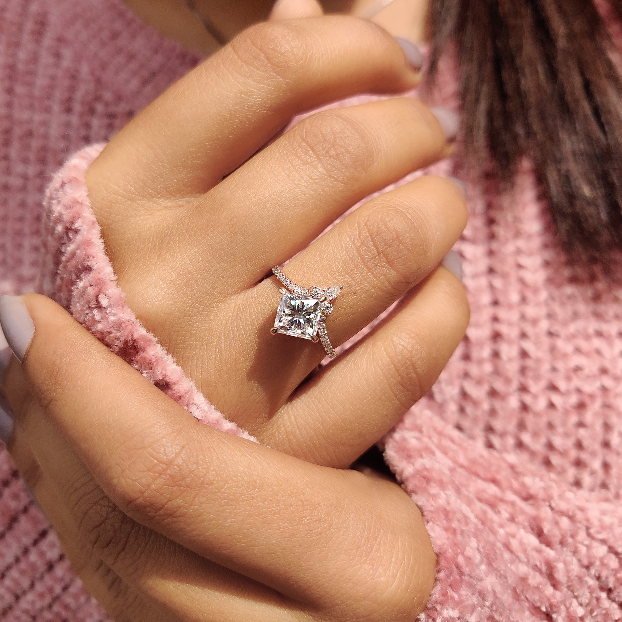 Pear cut moissanite ring in unique compass setting