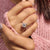 Pear cut moissanite ring in unique compass setting