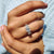 Unique engagement ring stands out with bold charm.