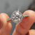Round cut moissanite engagement ring with halo setting ring
