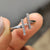 Round cut moissanite ring designed with a simple band.
