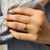 Minimalist wedding band featuring round moissanite stones in a simple, understated design.