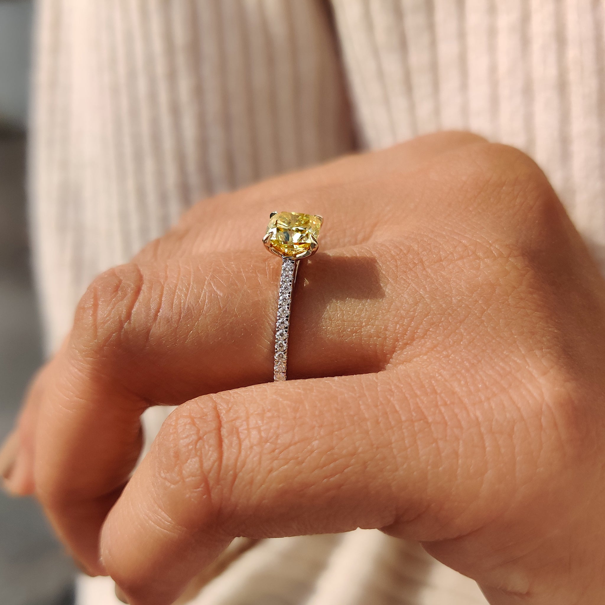 White gold ring with round cut Moissanite stones in a pave setting, offering a brilliant and modern engagement look.
