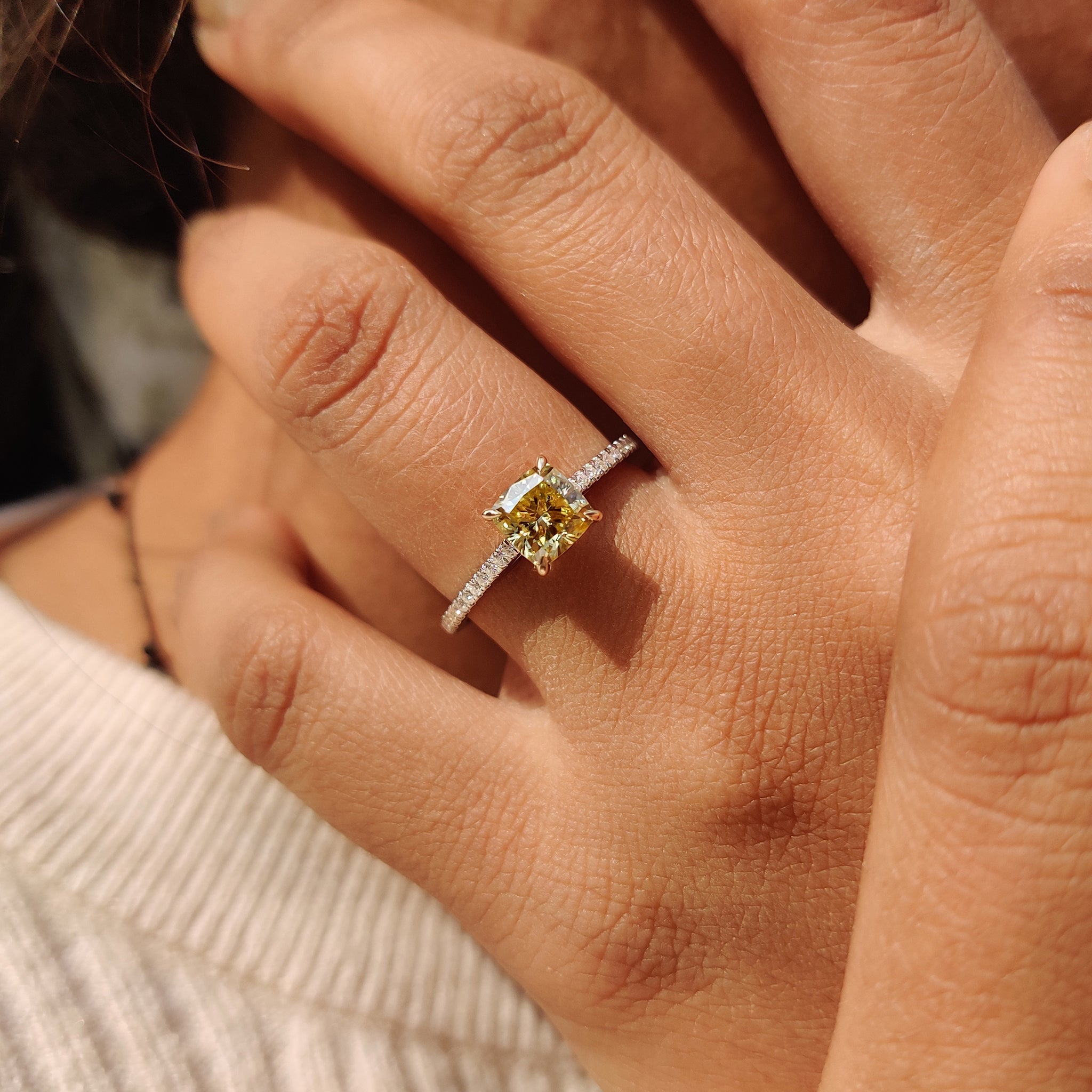 Custom engagement ring crafted with precision, showcasing a round cut Moissanite stone and claw prong setting.
