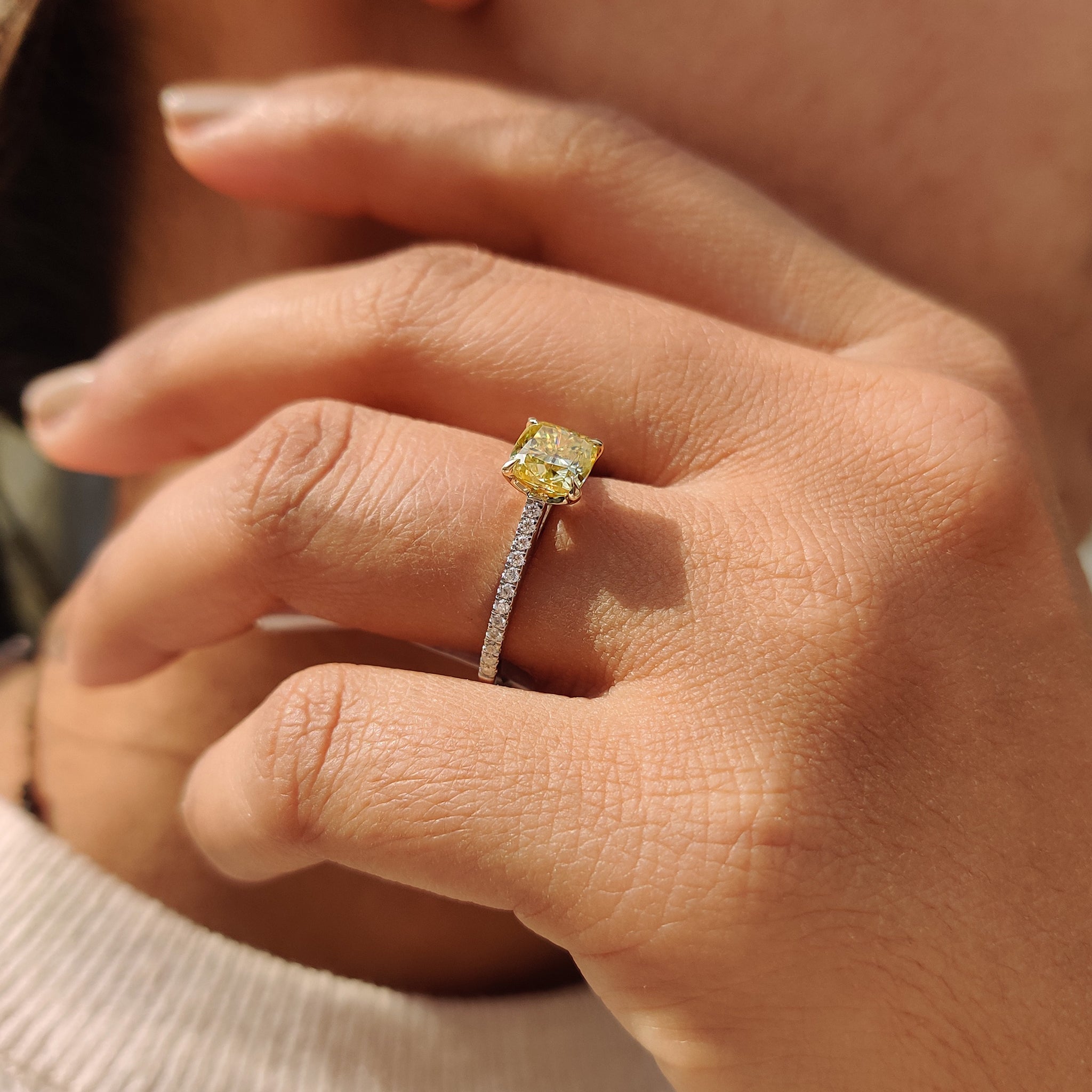 Round cut pave engagement ring with a white gold band and Moissanite stone, perfect for a timeless proposal.
