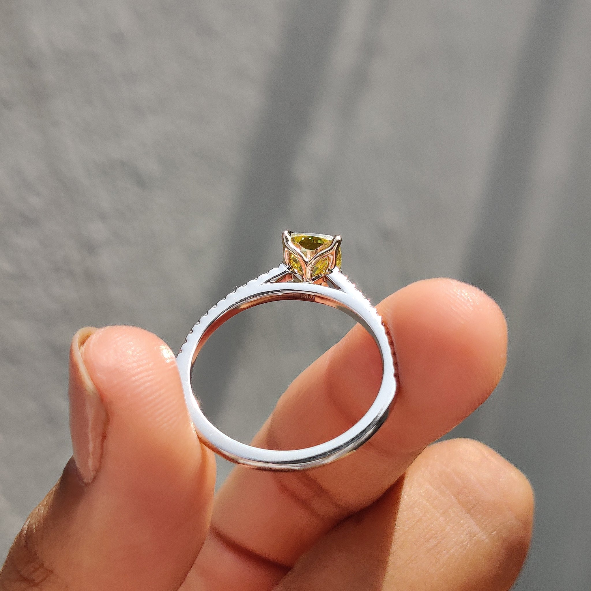 Two-tone engagement ring with a combination of yellow gold and white gold, setting off the Moissanite stone beautifully.
