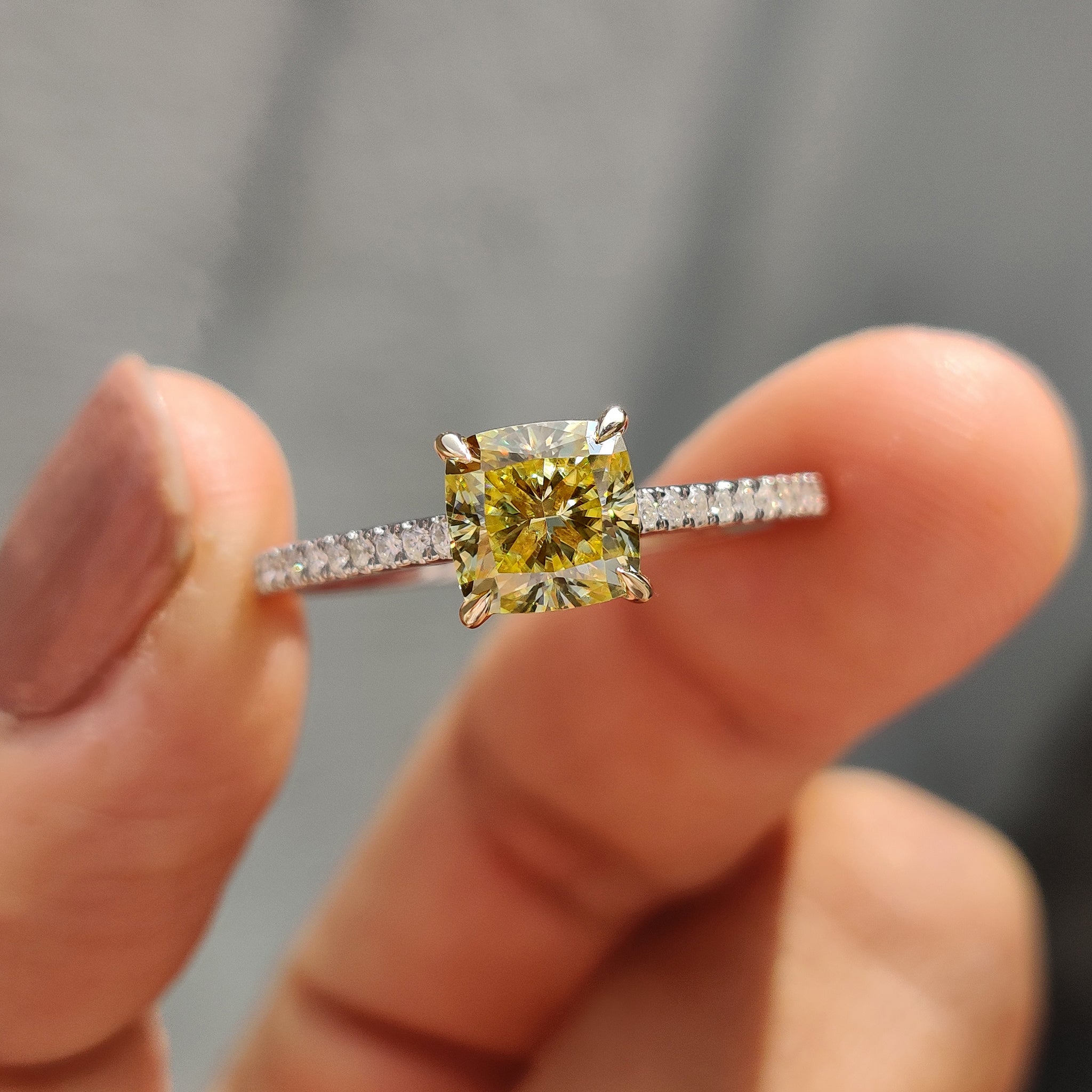 Yellow gold ring featuring a cushion cut Moissanite engagement stone, designed for a unique proposal.
