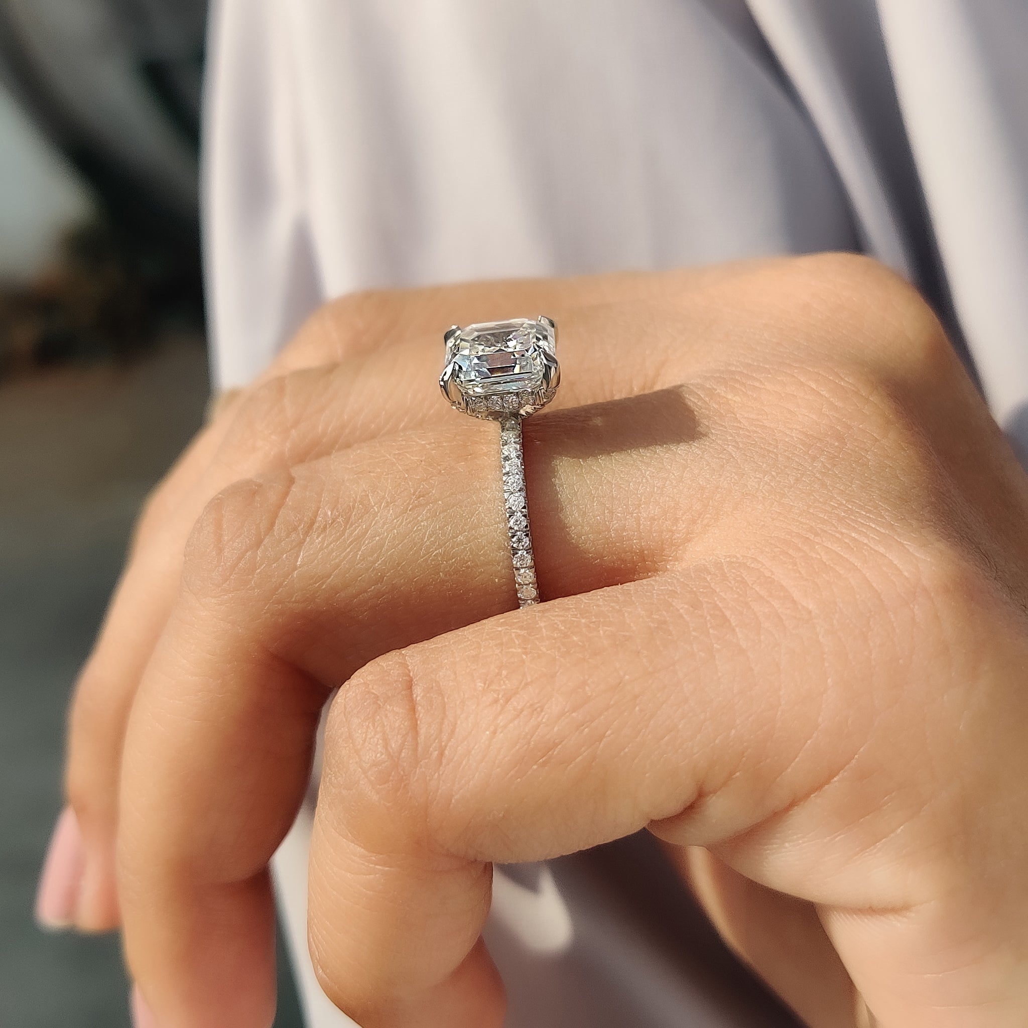 White gold engagement ring with asscher cut center.
