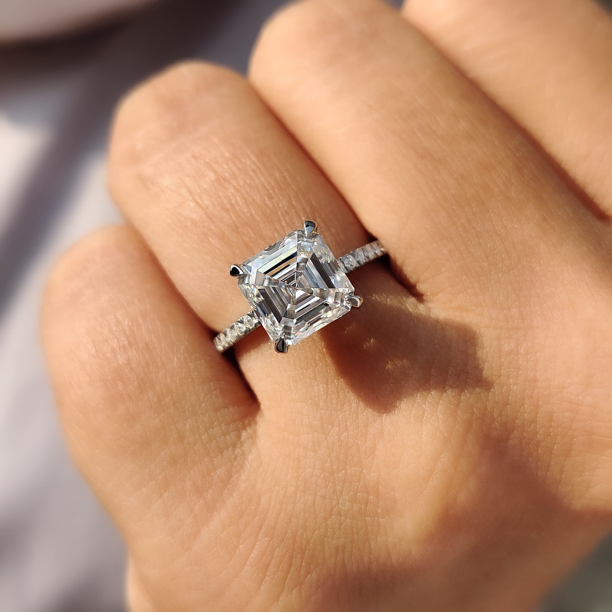 Moissanite engagement ring with modern halo style.
