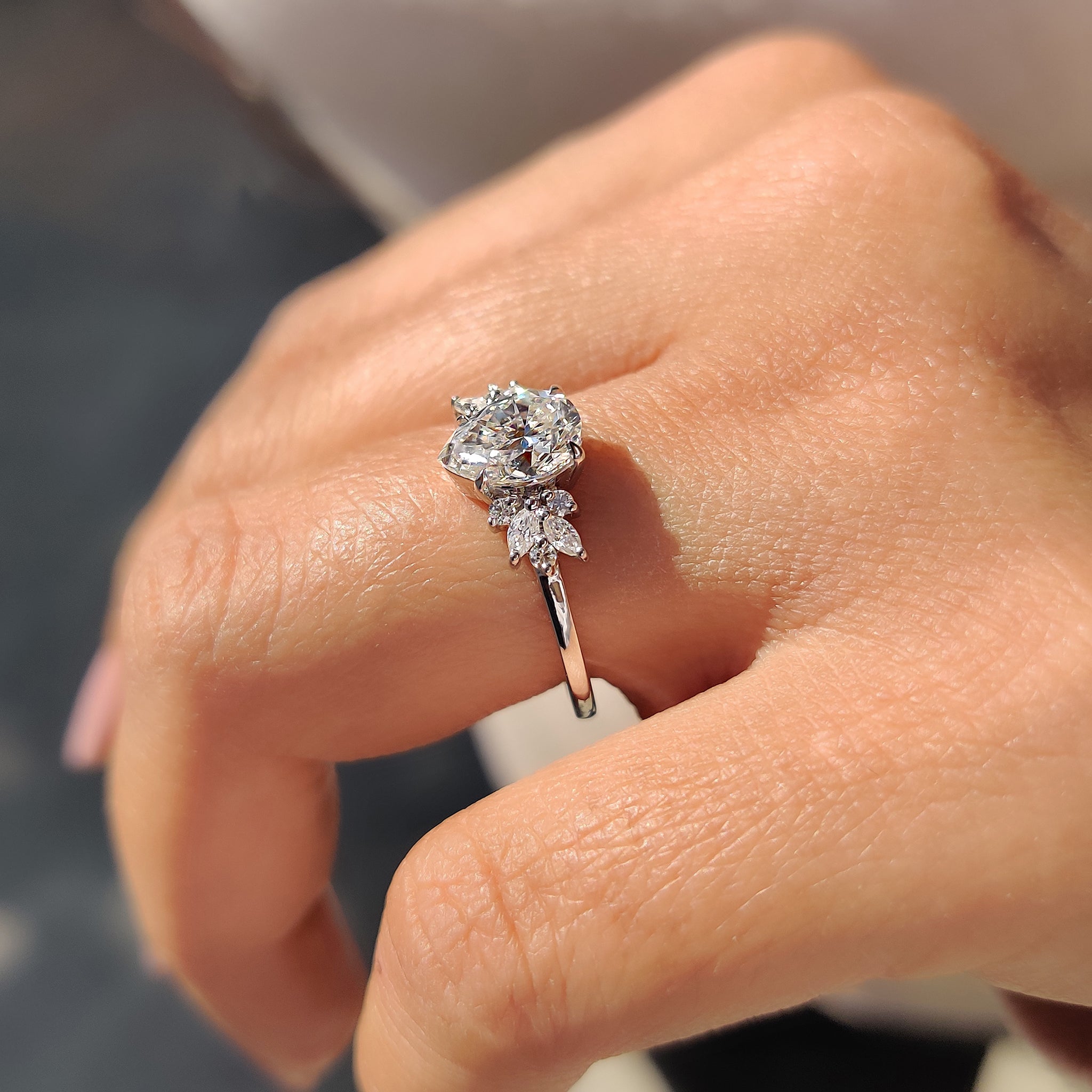 Unique Moissanite engagement ring with marquise and round side stones