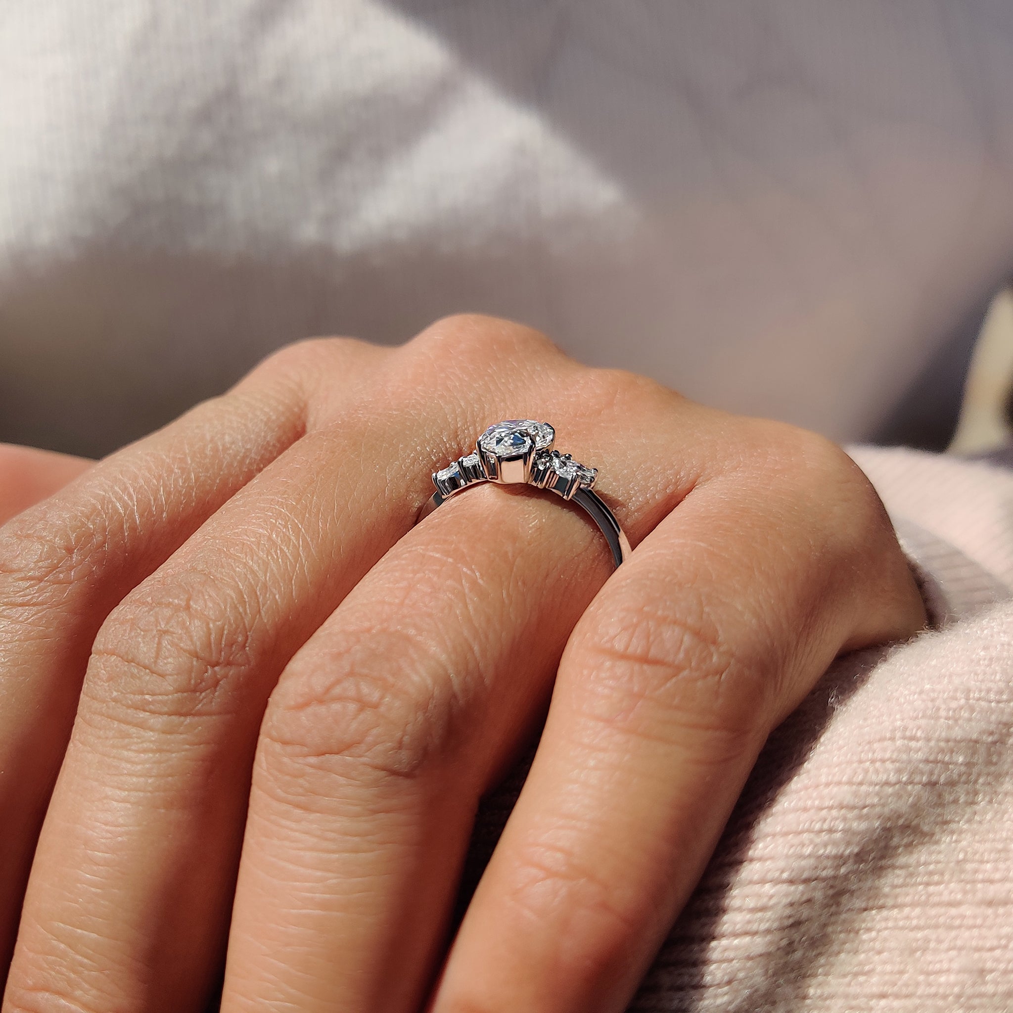 Moissanite pear ring with four claw prong setting