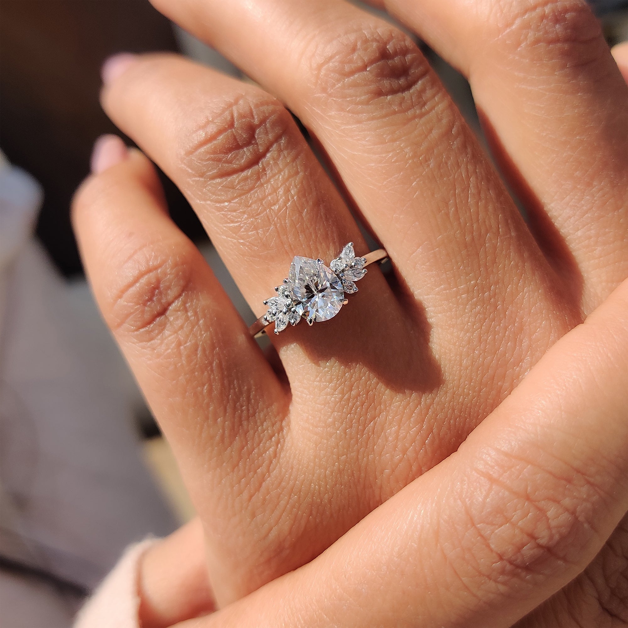 Carat Diamonds Moissanite ring with marquise and round side stones