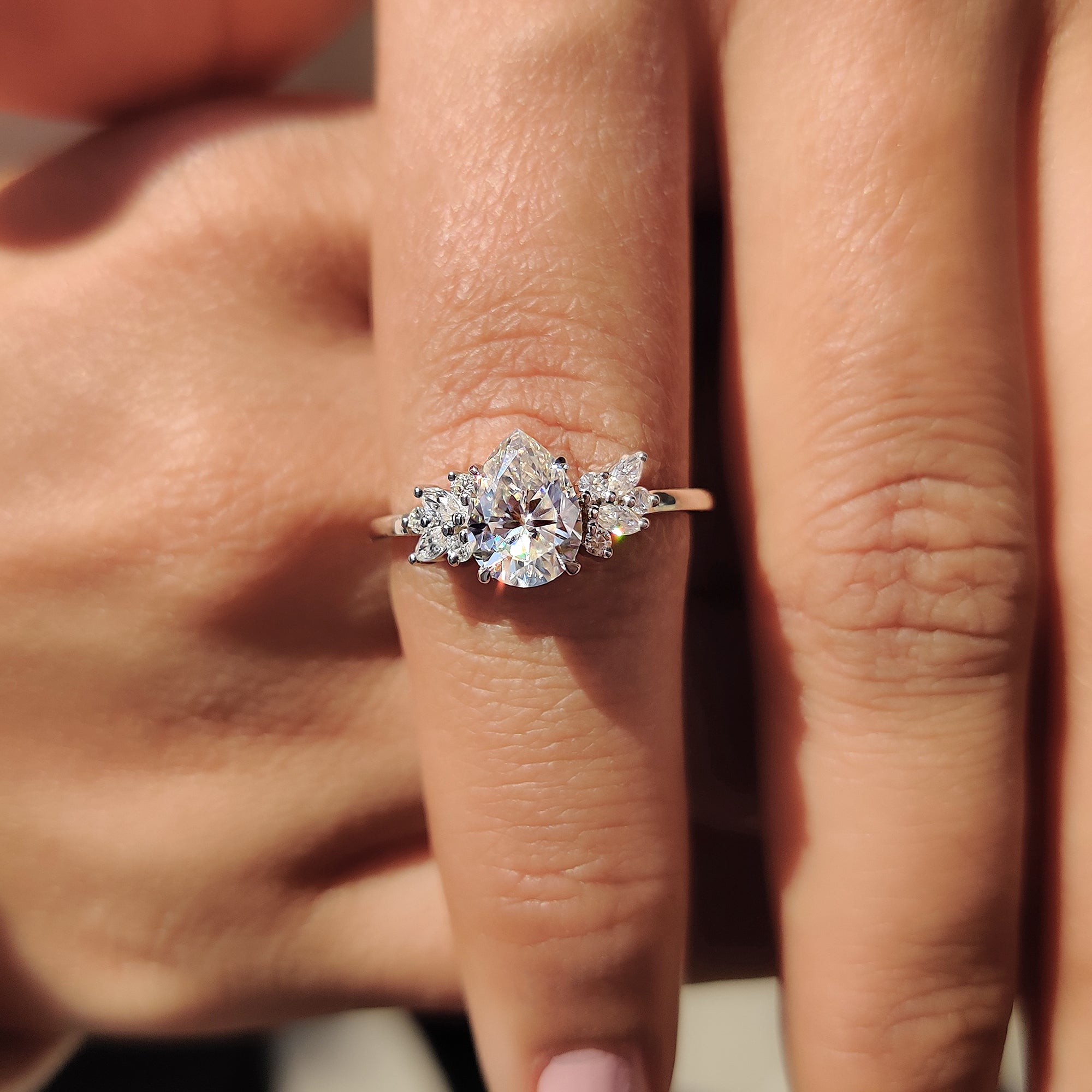 Moissanite Muse ring with pear cut center stone
