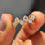 Round cut wedding band in yellow gold with prong setting.