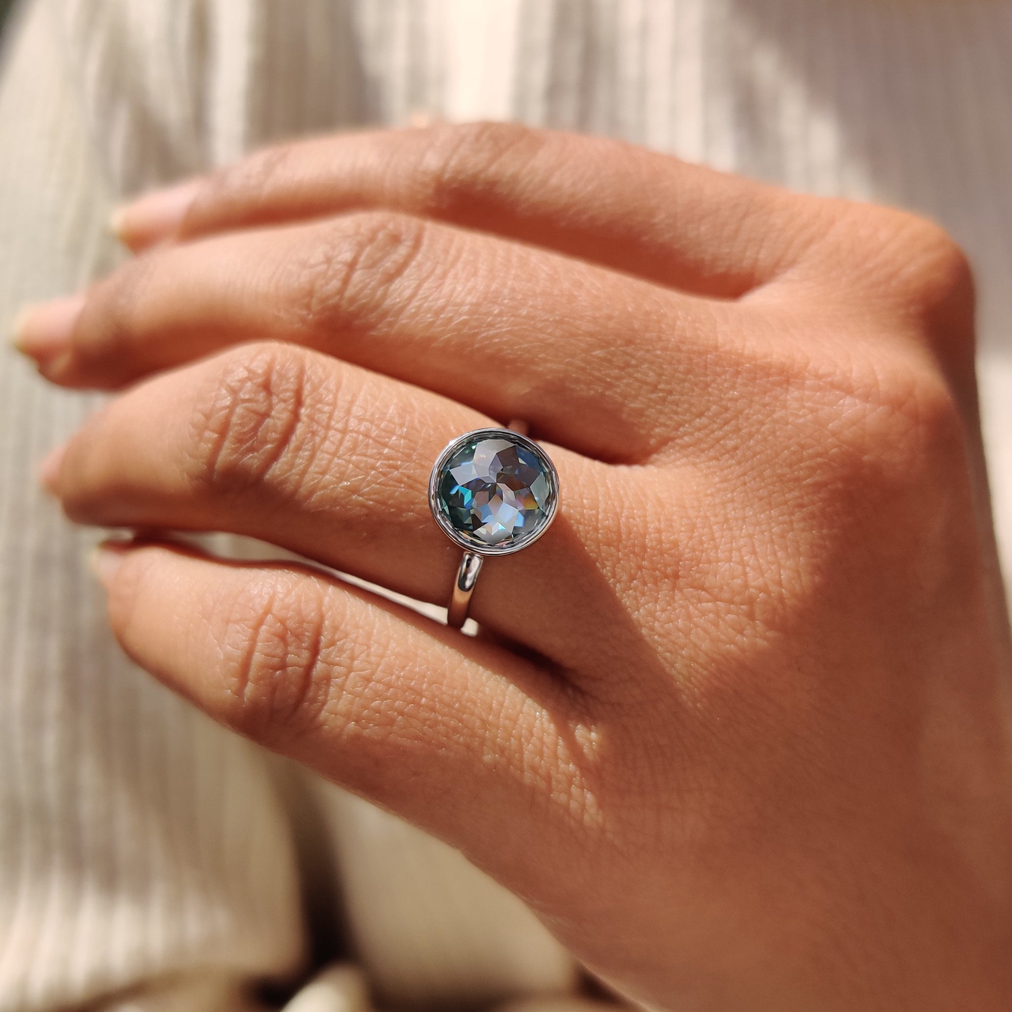 Best engagement ring with a green round rose cut Moissanite stone in a bezel setting.
