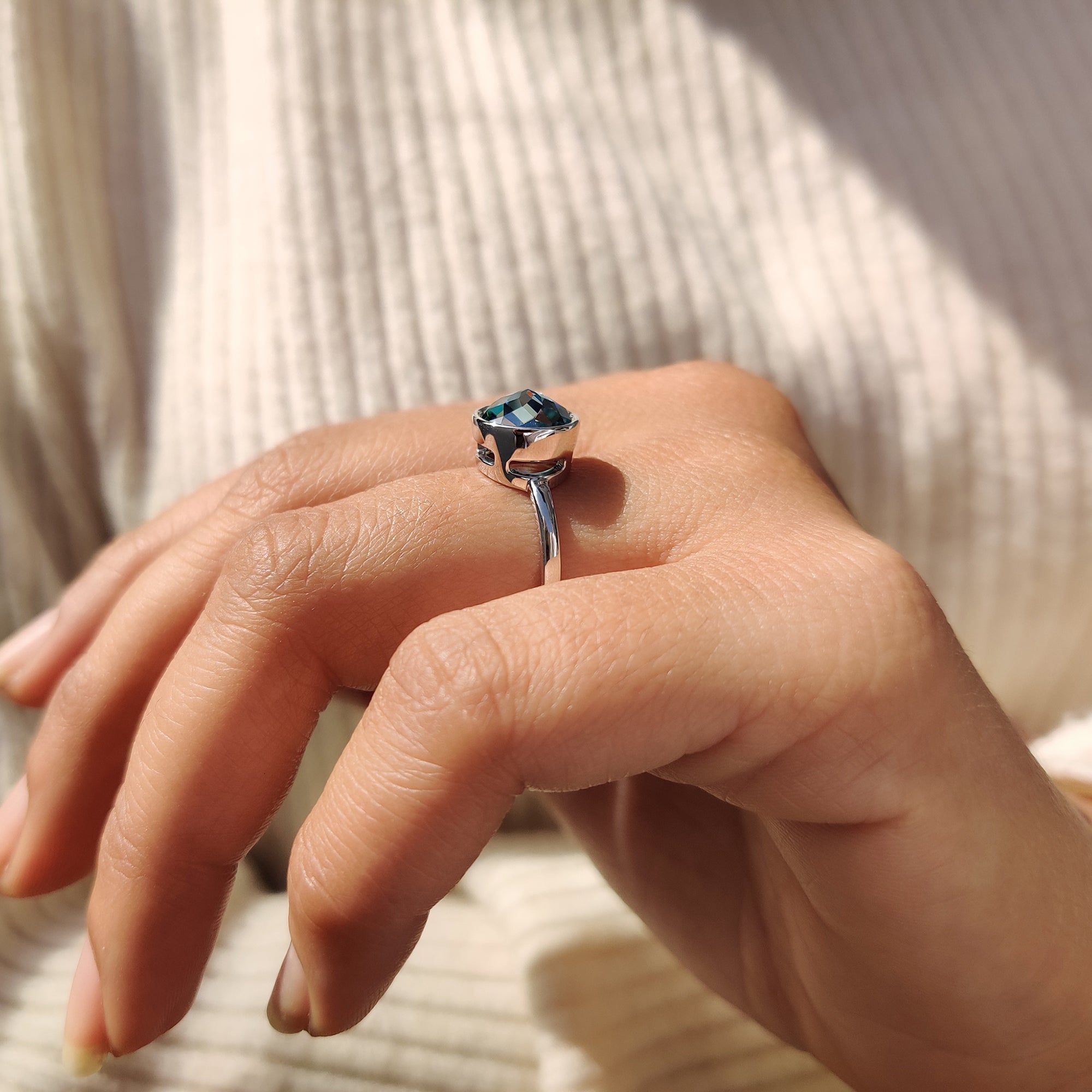 Simple ring design with a green round rose cut Moissanite in a classic solitaire setting.
