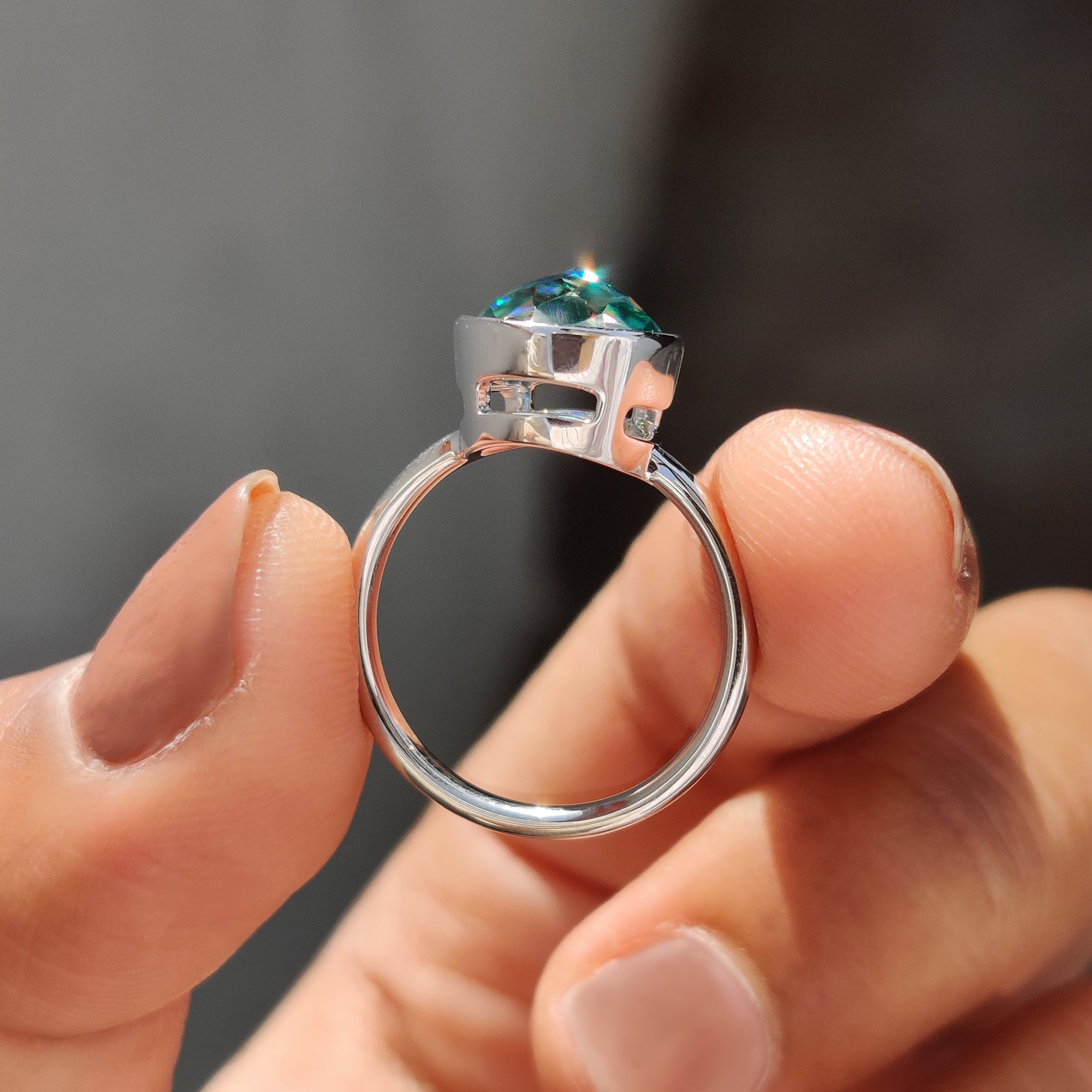 White gold engagement ring with a green round rose cut stone, perfect for a unique proposal ring.
