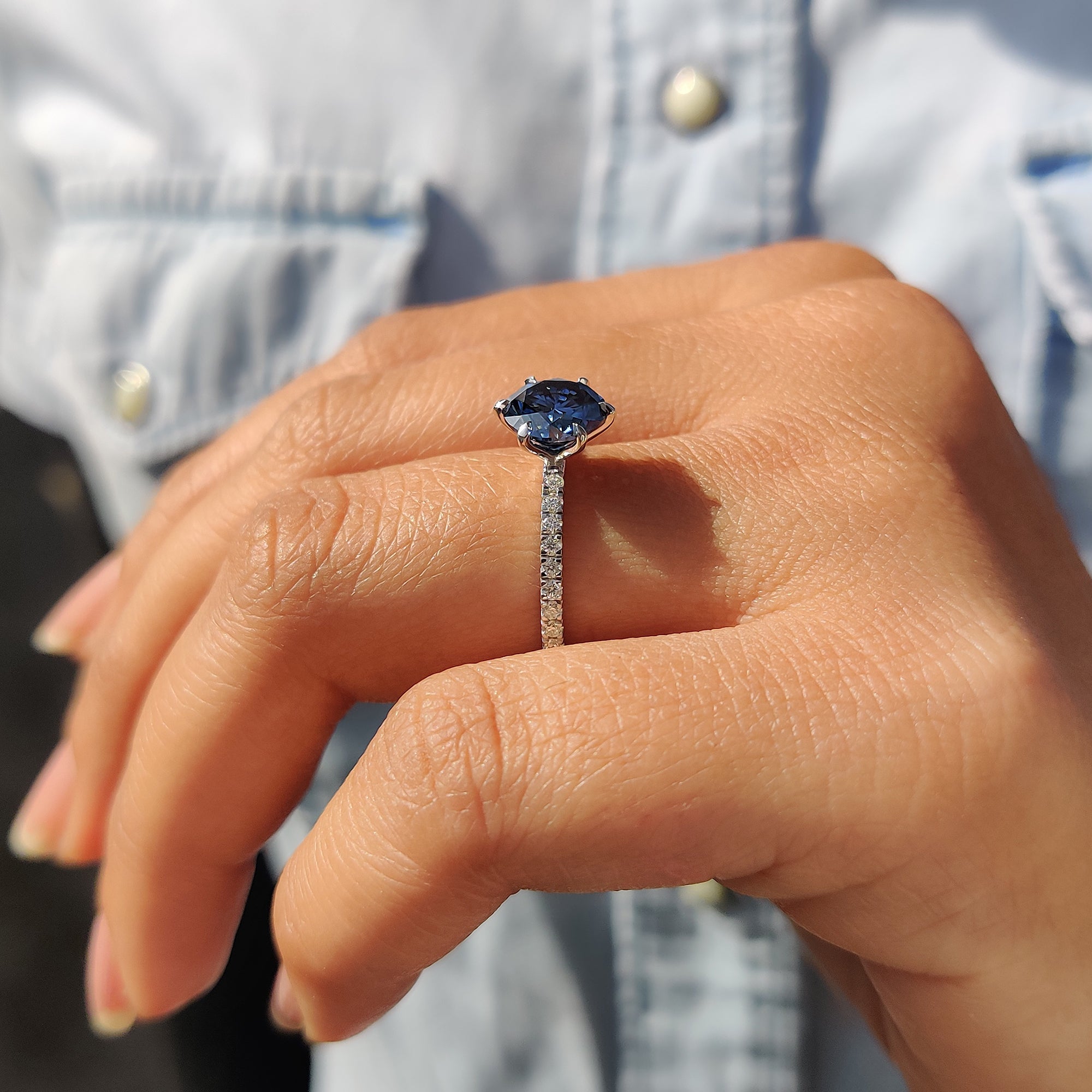 Round cut pave band with royal dark blue round Moissanite set in a classic 6 claw prong setting.

