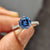 Round pave engagement ring featuring royal dark blue round cut Moissanite in a 6 claw prong setting.
