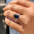 Unique engagement ring with royal dark blue pear cut Moissanite in a white gold 3 claw prong setting.
