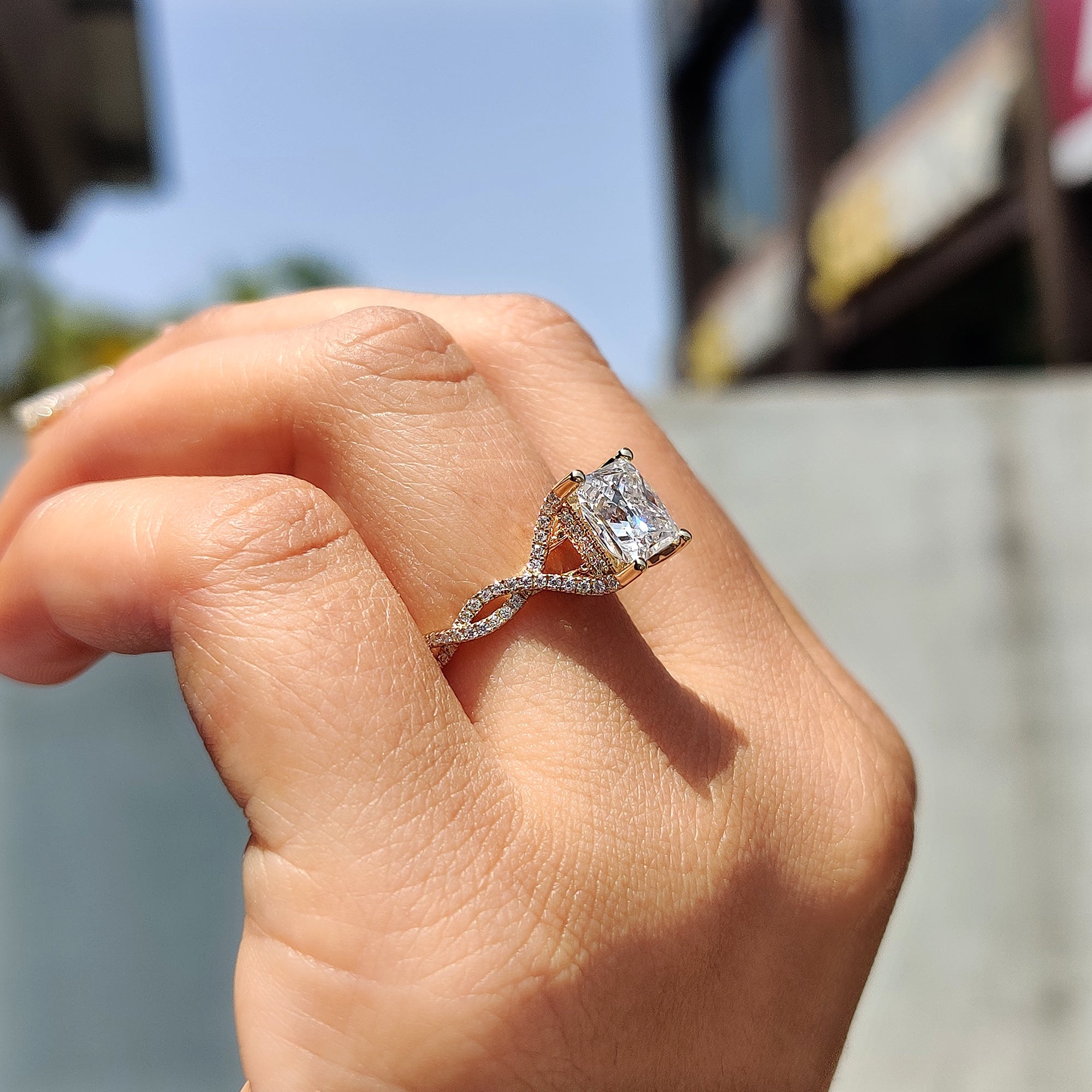 Round cut side stone ring with a hidden halo design for a sophisticated look.