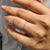 Half eternity wedding band featuring sparkling round diamonds.
