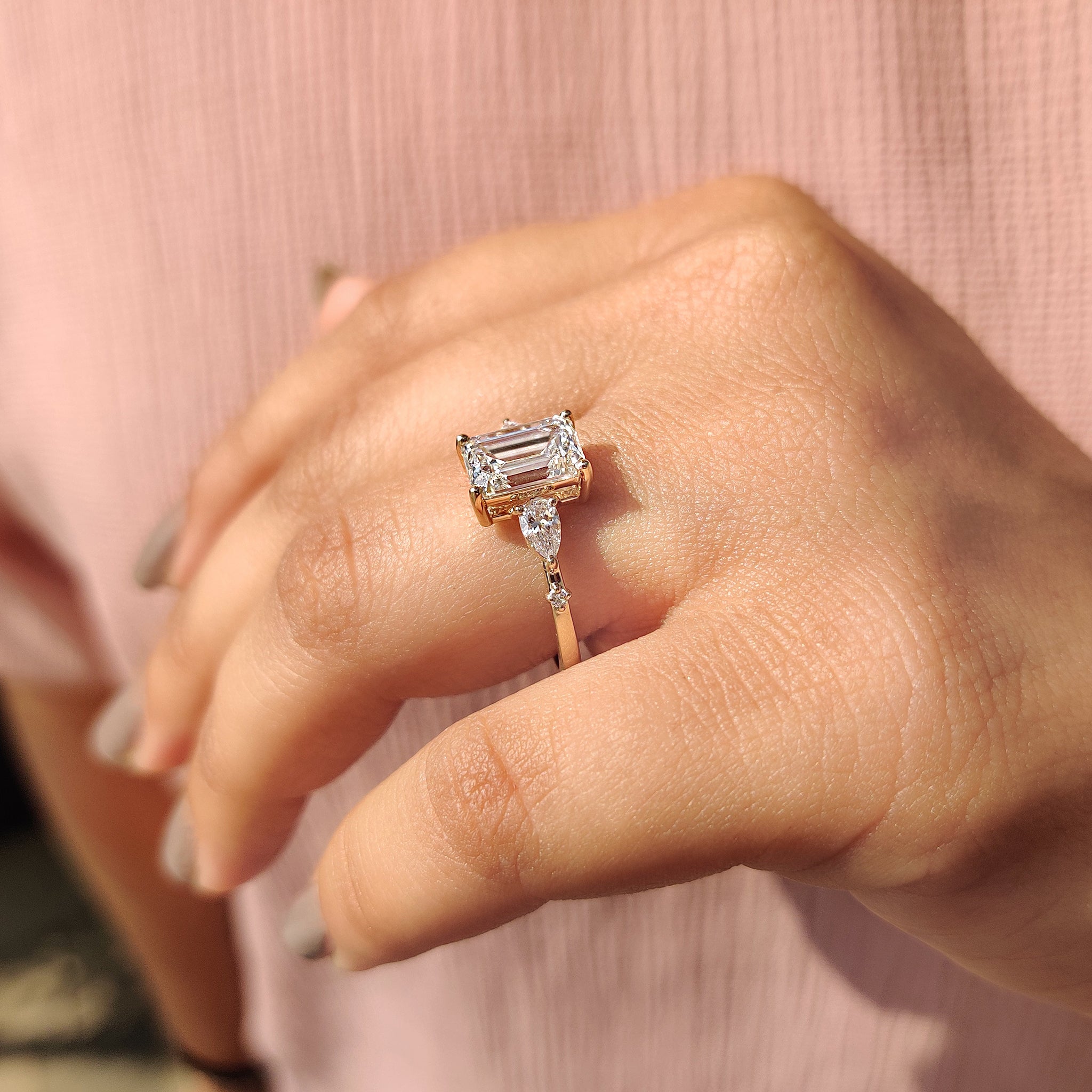 Yellow gold prong setting ring with lab grown emerald cut diamond.
