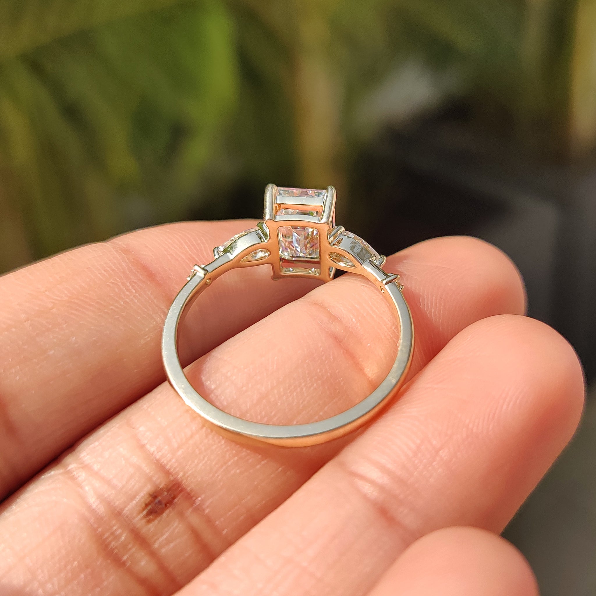 Handmade ring with emerald cut center and pear side stones.
