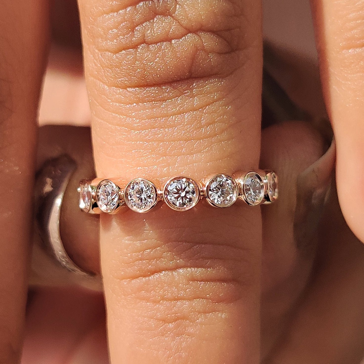 Bezel set wedding band with a sleek modern finish.
