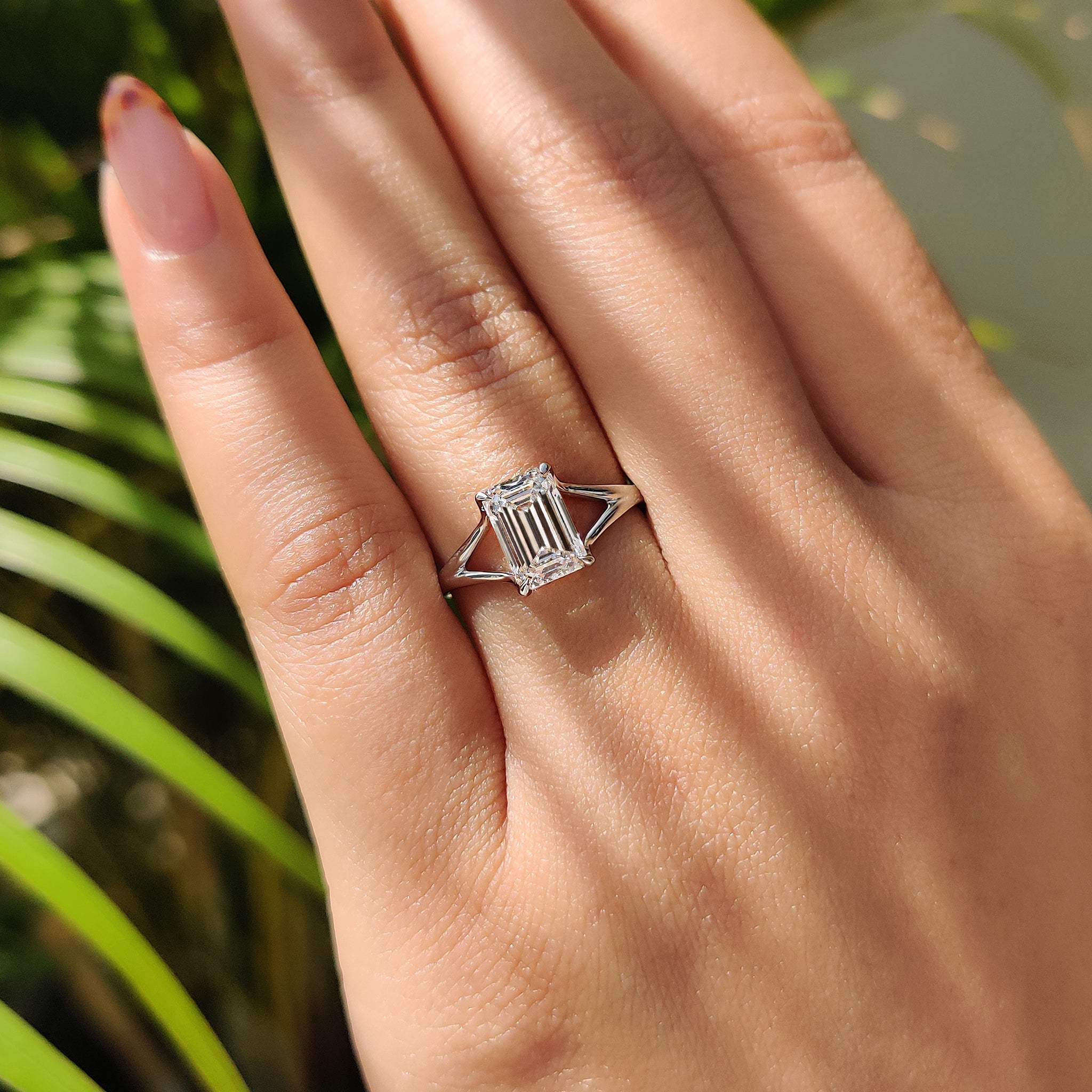 Lab-grown emerald cut diamond solitaire ring with a four-claw prong setting, offering a clean and modern design in white gold.
