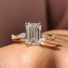 Stone Emerald Cut Diamond Ring set in yellow gold, featuring a marquise and round cut design with a four prong ring setting.
