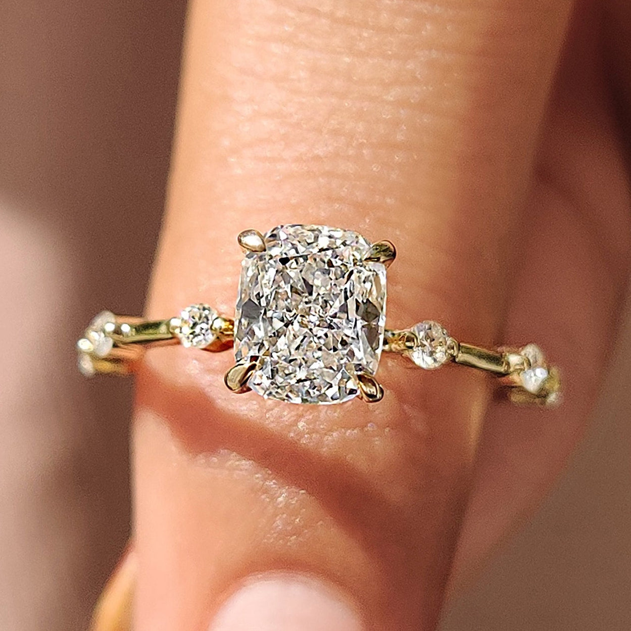 Seven Stone Diamond Ring featuring cushion cut diamonds in a yellow gold band.
