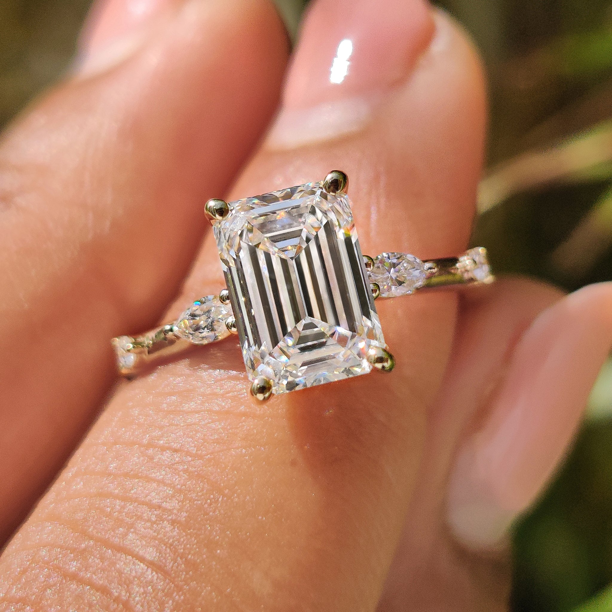 Handmade jewelry with a carat diamonds engagement ring featuring a sleek emerald cut diamond in a four prong ring setting.
