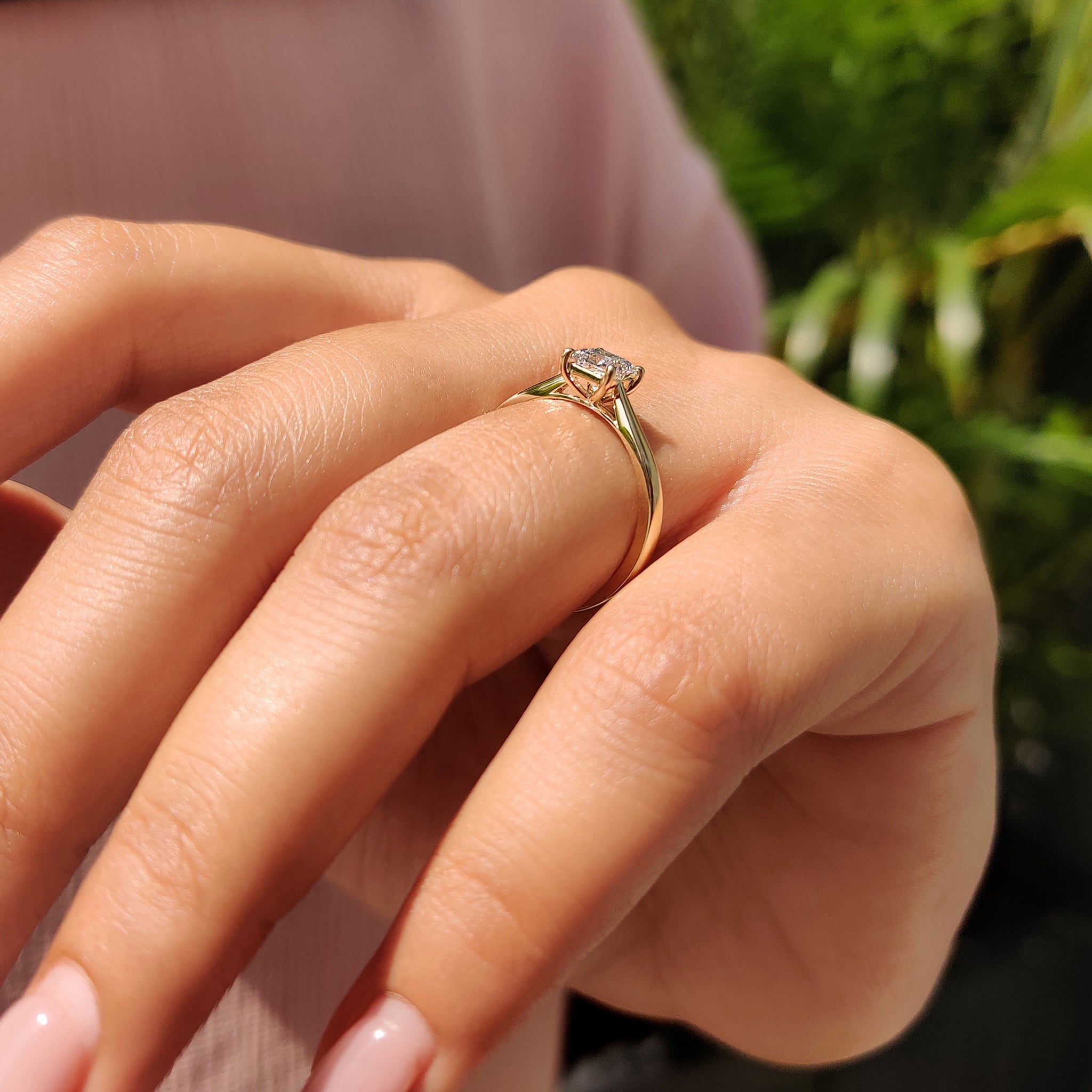 Princess cut solitaire diamond ring in cathedral setting, crafted from yellow gold with a tapered shank.
