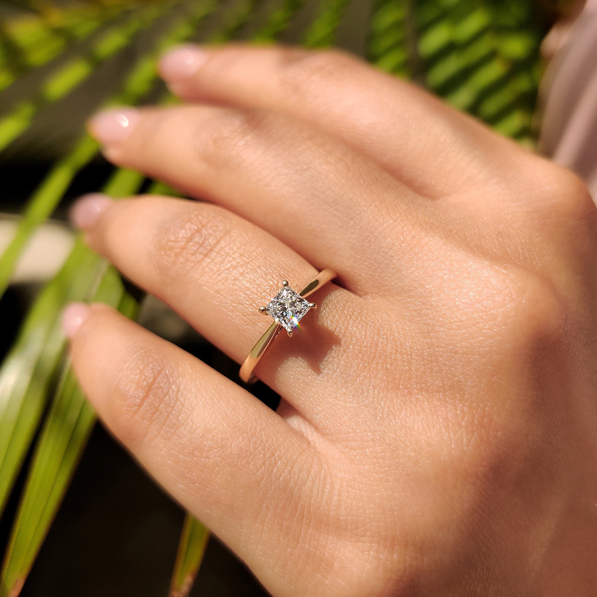 Yellow gold ring with a 4 prong setting holding a princess cut IGI certified lab-grown diamond.
