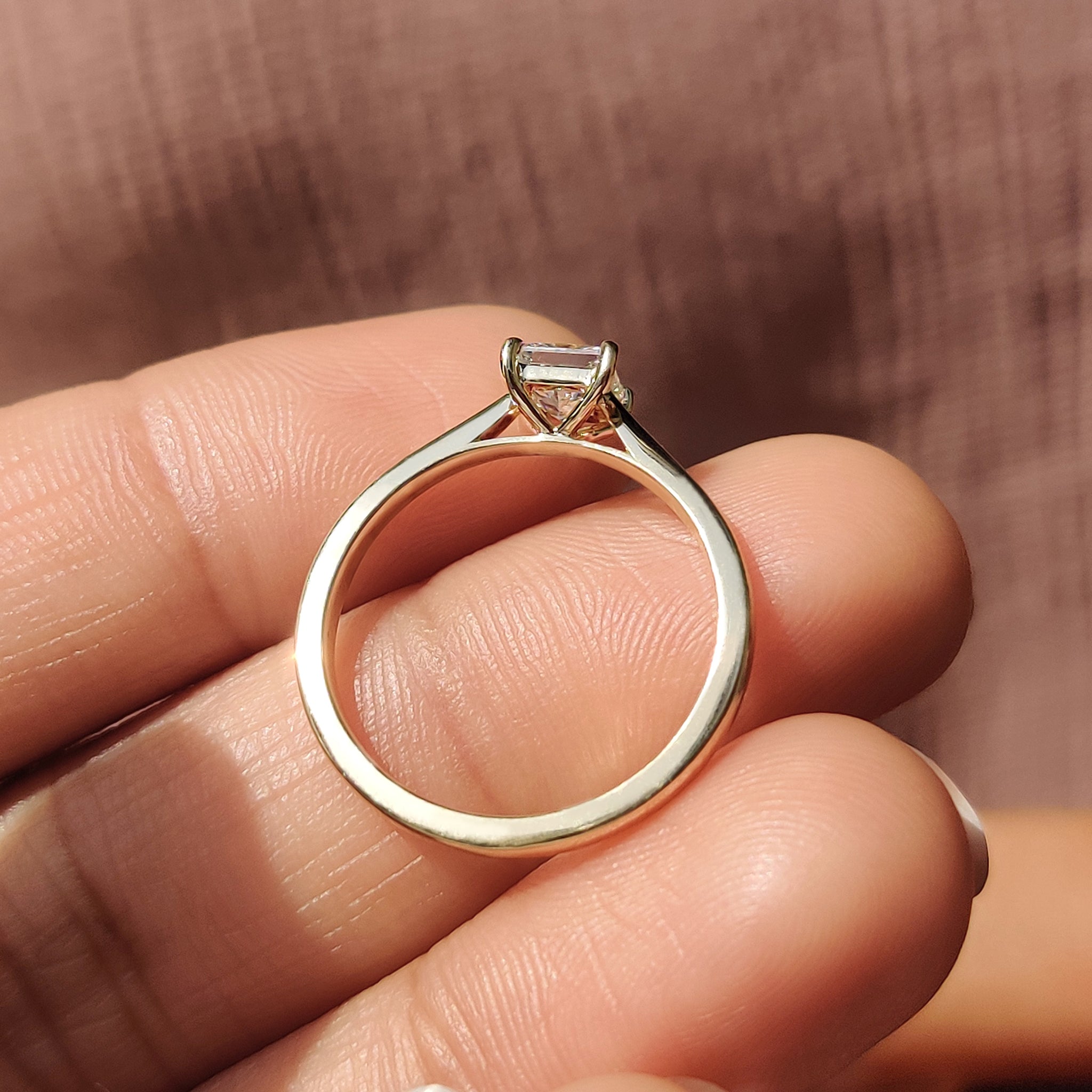 Handmade yellow gold ring with a princess cut solitaire diamond in a 4 prong setting.
