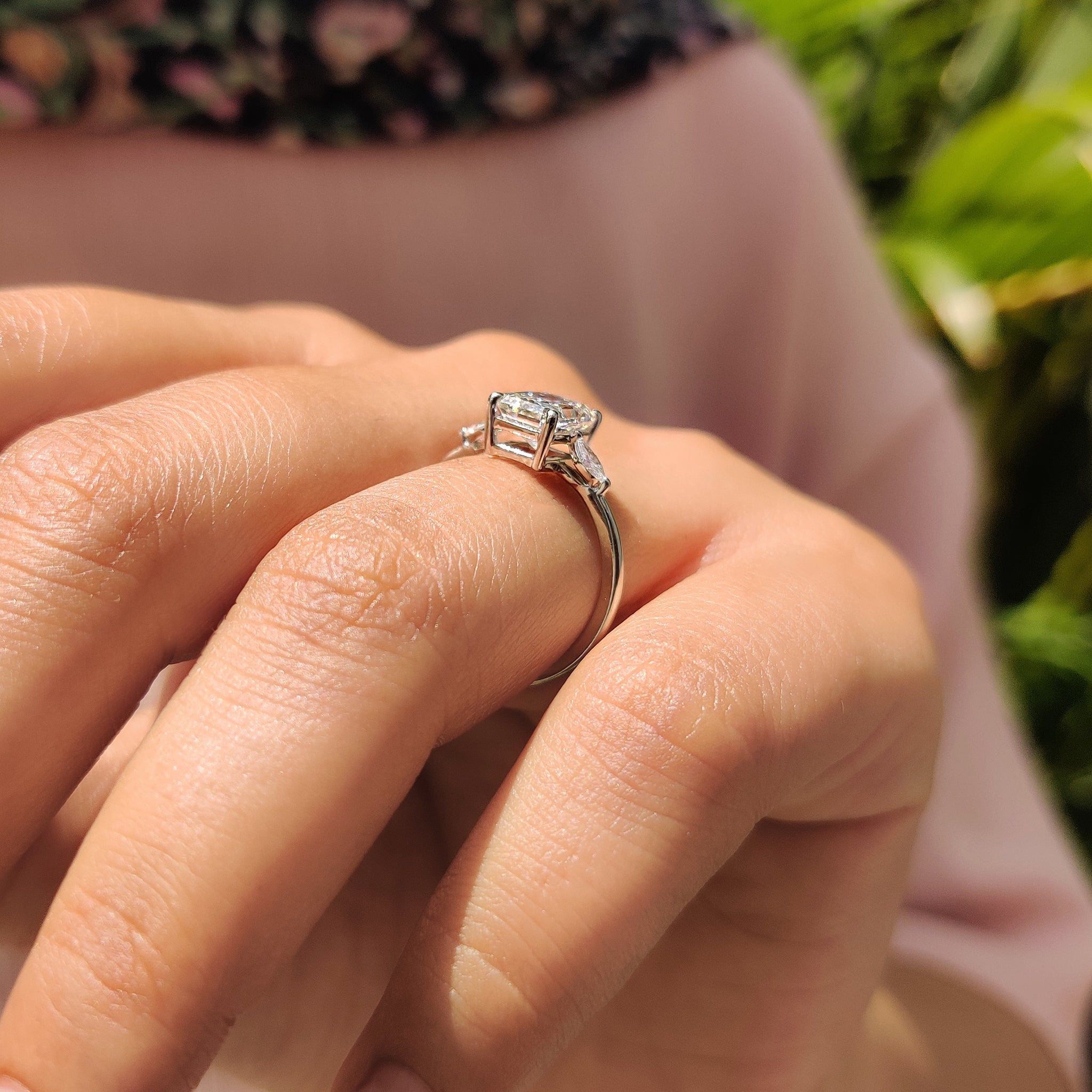 Carat Diamonds Ring with a radiant cut center diamond and marquise side stones in yellow gold.
