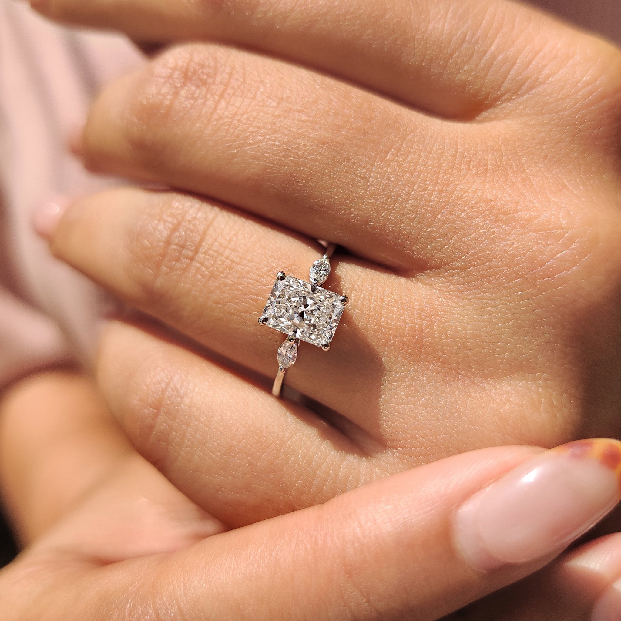 4 Prong Ring Setting with a radiant cut diamond and marquise side stones in yellow gold.
