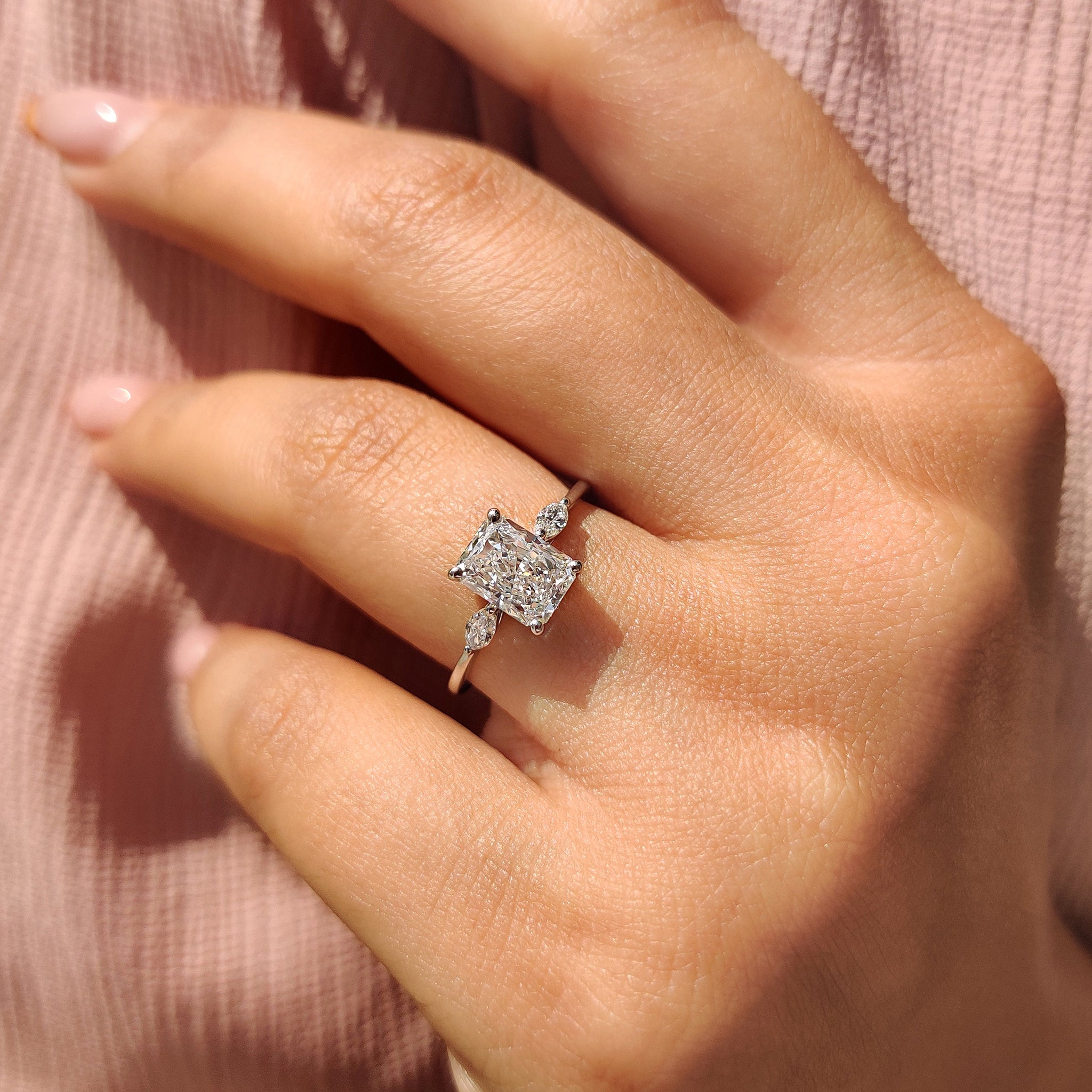 Handmade Engagement Ring with radiant cut and marquise side stones, crafted with lab grown diamonds.
