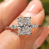Radiant Cut Diamond Ring with marquise side stones in a yellow gold setting.

