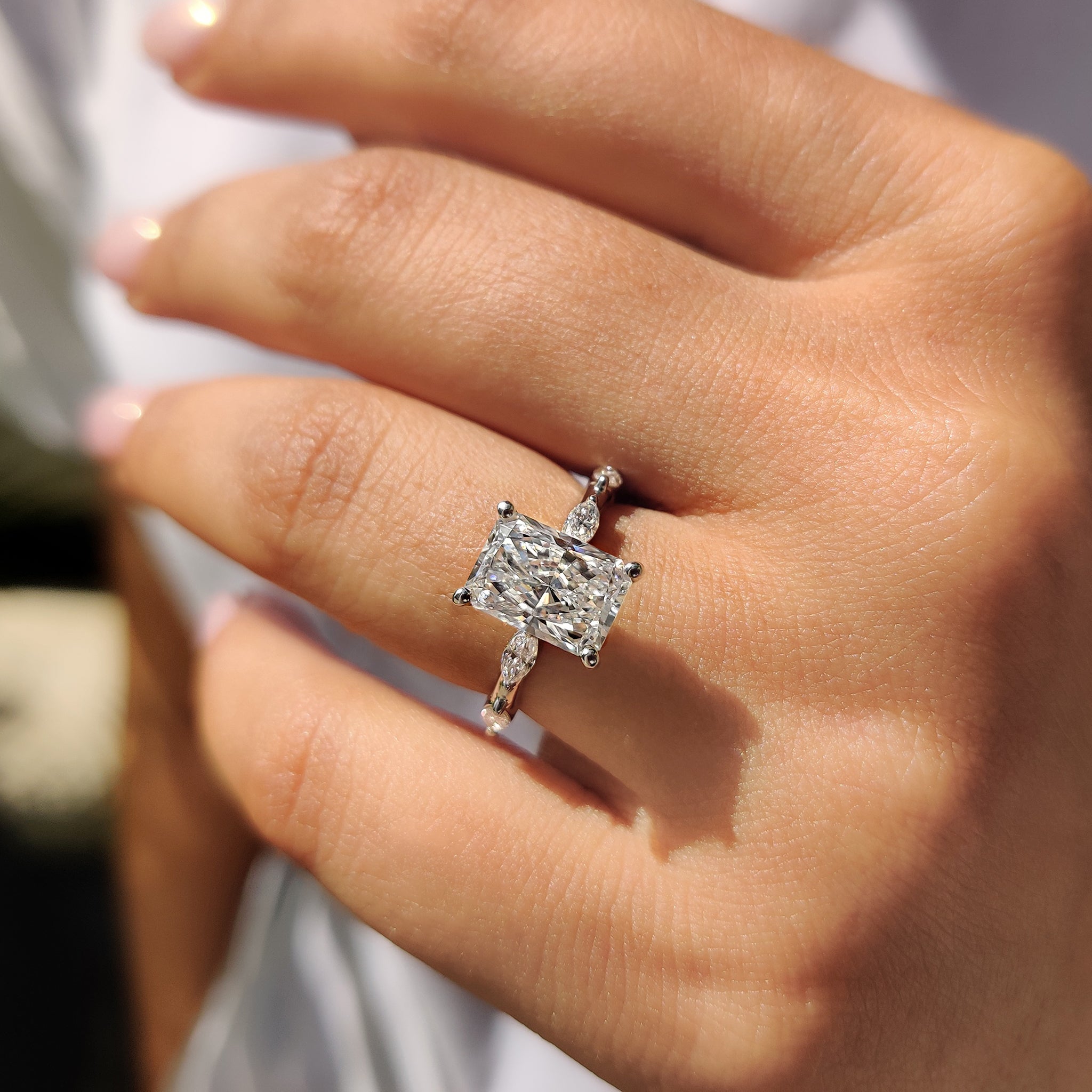 Handmade jewelry featuring a round and marquise cut engagement ring with pave set diamonds.
