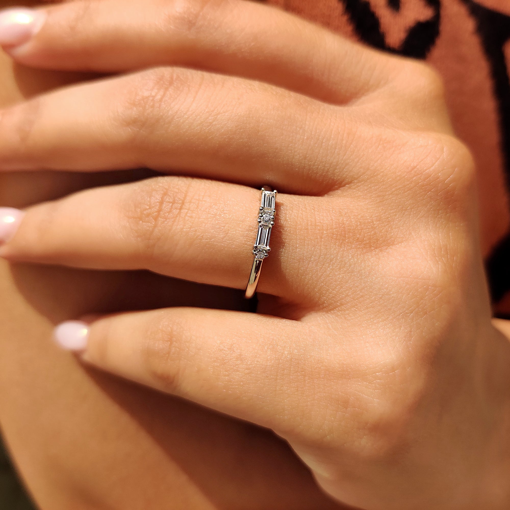 Elegant white gold band with intricate craftsmanship and sparkling diamonds.
